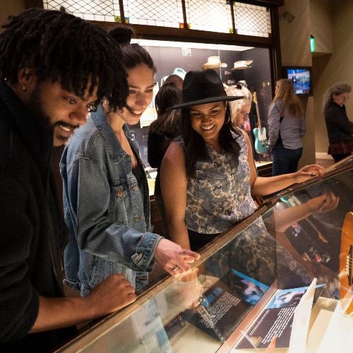 Guests looking at display cases during a Ryman tour