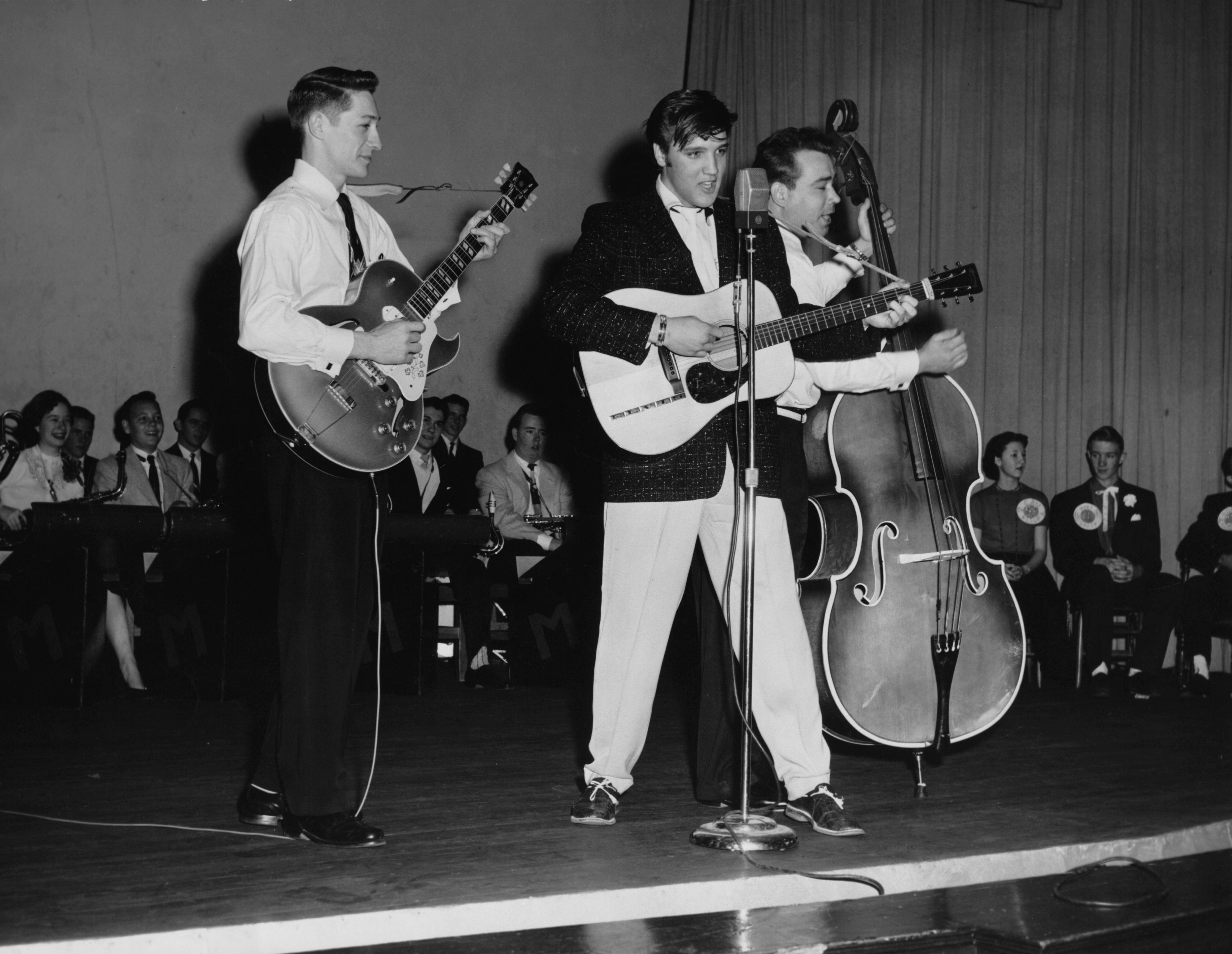 Elvis Presley and bandmates performing on the Opry stage