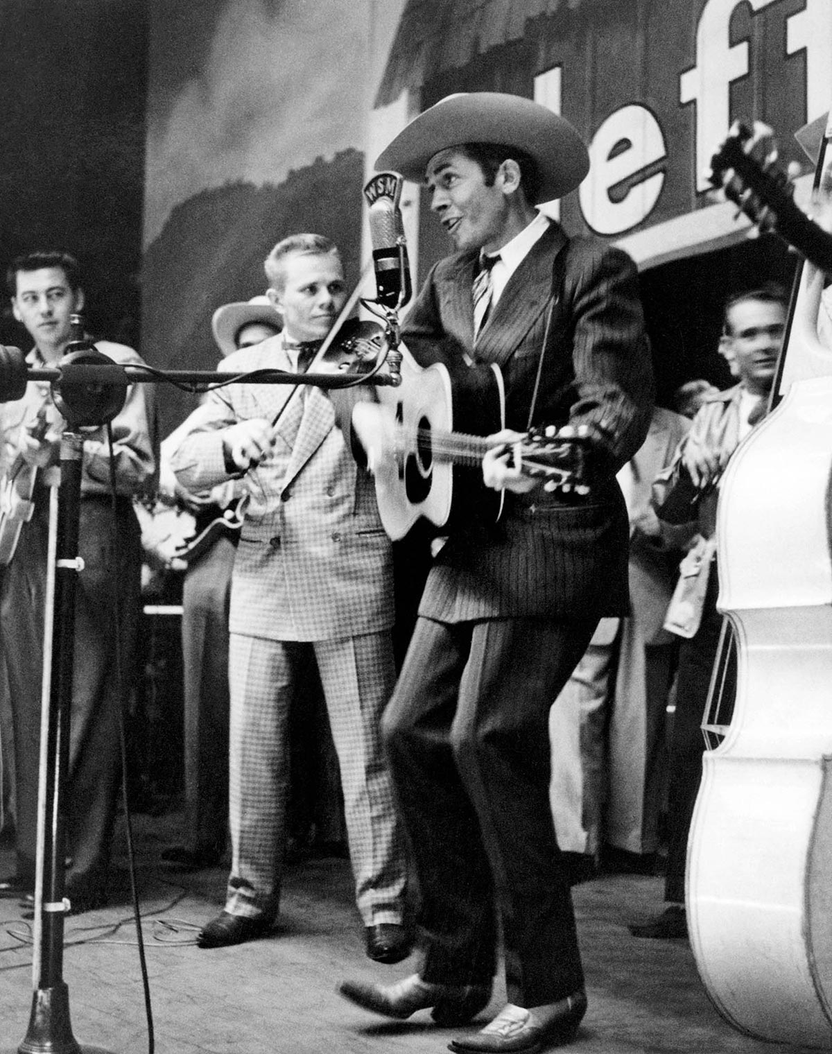 Hank Williams performing on the Grand Ole Opry wearing the suit that is now on display